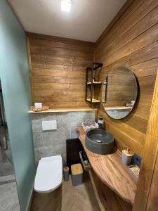 a bathroom with a sink and a mirror at SweeDom Shale in Almaty