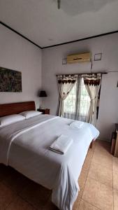 En eller flere senge i et værelse på @House of Belva Pleret Balong Waterpark