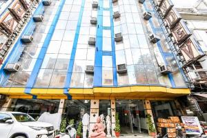um edifício com uma fachada azul e amarela em Hotel Shivdev International em Nova Deli