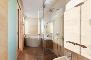 a bathroom with a tub and a sink and a shower at Villa Hedonism in Sveti Stefan +27 photos