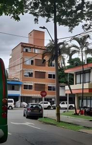 a building with a stop sign in front of a street at Apartaestudio 301 velódromo in Medellín