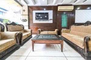 a living room with two couches and a coffee table at Hotel Shivdev International in New Delhi