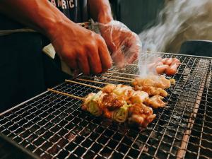 a person is cooking food on a grill at ホロホロバイライフタイム in Furugen