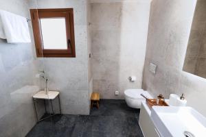 a bathroom with a white toilet and a sink at Kula Kerameikos in Athens