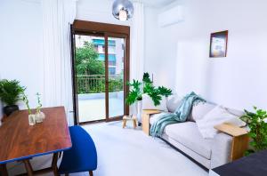 a living room with a couch and a table at Kula Kerameikos in Athens