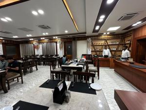 a restaurant with people sitting at tables in a room at The Heritage in Dumka