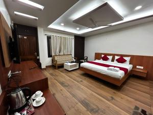 a hotel room with a bed and a table at The Heritage in Dumka +18 photos