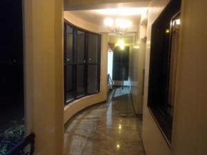 un couloir vide avec un lustre dans un bâtiment dans l'établissement Hotel Shubh Shree Bilaspur, à Bilāspur