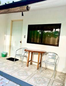 a table and two chairs on a patio at Green Garden Beach Resort, Sipalay in Sipalay