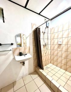 a bathroom with a sink and a shower at Green Garden Beach Resort, Sipalay in Sipalay +61 photos