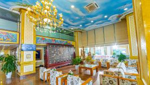 a restaurant with a chandelier and tables and chairs at Hoang Son Peace Hotel in Ninh Binh