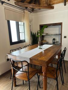 a dining room table with chairs and a wooden table at House from 1900 carefully restored in Santa Cruz de Tenerife