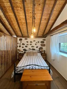 a bed in a room with a wooden ceiling at House from 1900 carefully restored in Santa Cruz de Tenerife