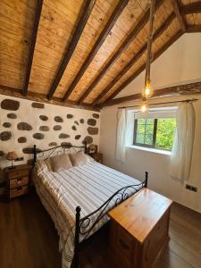 a bedroom with a bed and a wooden ceiling at House from 1900 carefully restored in Santa Cruz de Tenerife