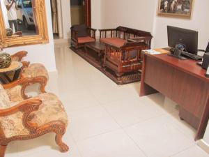 a living room with a desk and a chair at River-Ridge Guest House in Gaborone