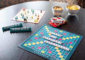 a table with a board game and snacks on it at Zeegalm Bungalows in Middelkerke