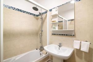 a bathroom with a sink and a toilet and a tub at Olilou - Seaview Studio in Portimão +12 photos