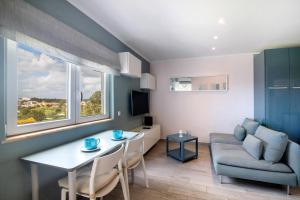 a small living room with a table and a couch at Olilou - Seaview Studio in Portimão