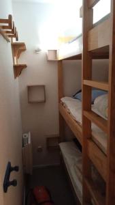 a small room with two bunk beds in it at Découverte de la vallée d'Eyne et des bains de Llo in Eyne