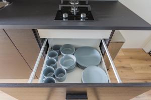 a kitchen island with a bunch of dishes in it at Casa Luijben Zwaanshoek in Zwaanshoek