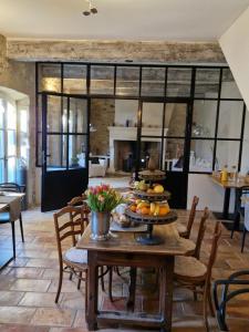 a dining room with a table with a cake on it at Mas Armelin in Tarascon