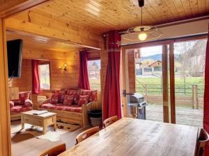 a living room with a table and a couch at Le chalet des Broches - jacuzzi in Xonrupt-Longemer