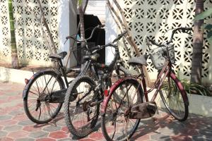 two bikes parked next to each other in front of a building at AHHA Boutique Kampot in Kampot