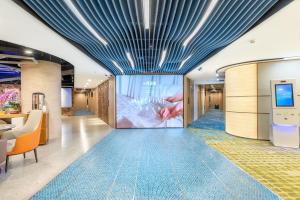 an empty lobby with a large screen in a building at Lemon Hotel - Metro Line 1 Line 7 Changshu Road 200 meters in Shanghai