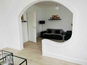 a living room with a couch and a table at Lovely 1-bedroom condo in Aarhus C in Aarhus