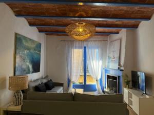 a living room with a couch and a fireplace at Beautiful apartment on the Costa Brava · Can Bosch in Sant Feliu de Guixols