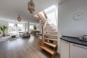 a living room with a spiral staircase in a house at Zelle 43 in Münster