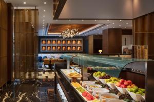 a buffet line with many different types of food at Sheraton Istanbul Esenyurt in Istanbul
