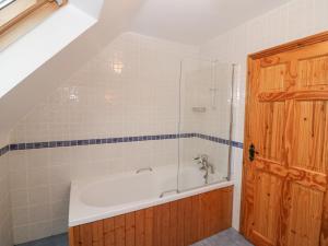 a bathroom with a bath tub with a glass door at The Skating Rock in Banane Bridge +30 photos