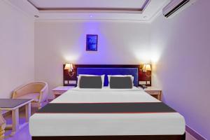a bedroom with a large bed and a table at Rohini Hills in Punalūr