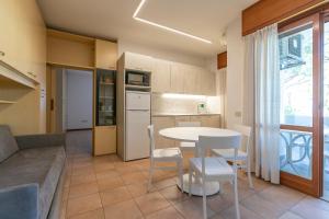 a kitchen and living room with a table and chairs at Residence Piccolo in Milano Marittima +38 photos