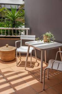 a table and two chairs and a table and a table and chairs at The Lane - Byron Bay in Byron Bay