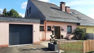 a house with a large garage in front of it at Haus am Ring in Spielberg