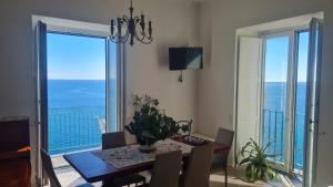 ein Esszimmer mit einem Tisch und Meerblick in der Unterkunft Casa Gargano Ravello Amalfi Coast in Amalfi