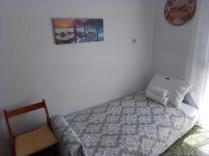 a bedroom with a bed and a picture on the wall at City Apartment Ierapetra 2A in Ierápetra