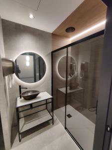 a bathroom with a sink and a mirror at Promotur Suites - Ayora in Valencia +77 photos