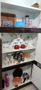 a shelf filled with dishes and other items at 2 BHK Apartment at Gachibowli in Hyderabad