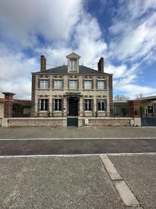 a large brick building with a gate in front of it at Bel appartement / Troyes in Saint-Parres-aux-Tertres