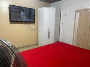 - un salon avec une télévision et une armoire blanche dans l'établissement Loft privativo ., à Macapá