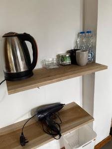 a tea kettle on a wooden shelf in a kitchen at Mountain vibe ella in Ella