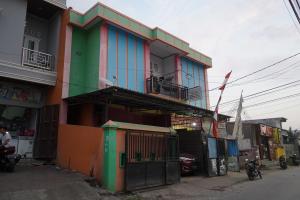 a colorful building on the side of a street at OYO 93876 Athirah Kost in Tolo
