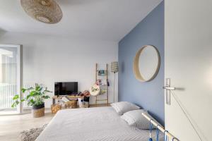 a bedroom with a bed with a blue wall at C4 Les Jardins d'Orsonville in Chessy