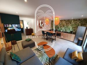 een woonkamer met een bank en een tafel bij Hyères : magnifique appartement Le Bois d Olivier in Hyères