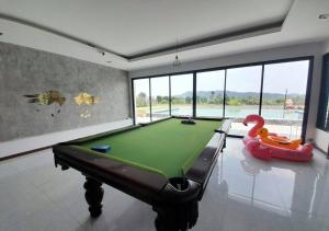 a room with a pool table and a rubber duck toy at Lsarl Pool Villa อิฏฐ์สรี พูลวิลล่า in Wangkata