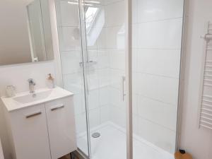 a white bathroom with a shower and a sink at Maison de campagne à la ville in Saint Pavace +48 photos