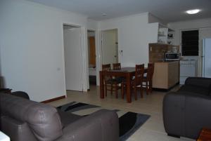 a living room filled with furniture and a table at Airlie Beach Apartments in Airlie Beach